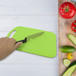 Set of plastic chopping board and steel knife for kitchen tasks