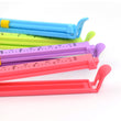 Plastic clip sealers for food pouches, large and multicolor.