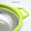 Green colander with water dripping