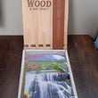 Elegant vertical wooden scenery art with hooks for wall decor.