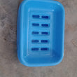 Covered plastic soap holder, helps in maintaining soap longevity.