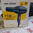 Hair dryer with stylish design and adjustable temperature settings.