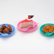 Snack set featuring a bowl, dish, and spoon in use.