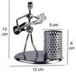 Pen stand with iron musician playing bass guitar, showpiece.