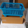 Dish drainer rack in a brown box, showing the plastic design for efficient drying