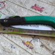 Folding saw for tree trimming and various cutting tasks, ideal for camping and gardening.