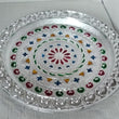 Silver plated pooja thali for religious ceremonies.