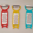 Set of kitchen tools including peeler, grater, and cutter for vegetables