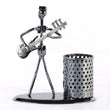 Showpiece of musician playing bass guitar, iron pen stand.